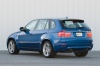 2013 BMW X5 M in Monte Carlo Blue Metallic from a rear left three-quarter view